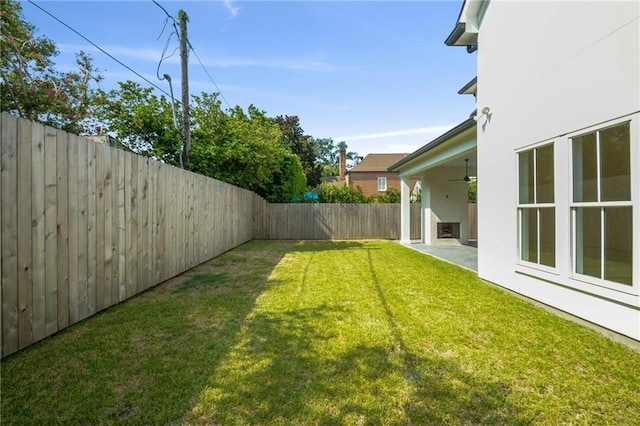 view of yard with a patio area and ceiling fan