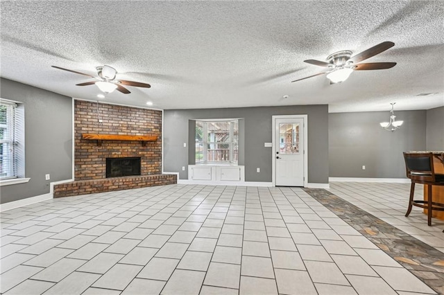 unfurnished living room featuring light tile patterned flooring, a fireplace, ceiling fan with notable chandelier, and a textured ceiling