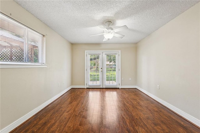 empty room featuring ceiling fan, french doors, a textured ceiling, and hardwood / wood-style flooring