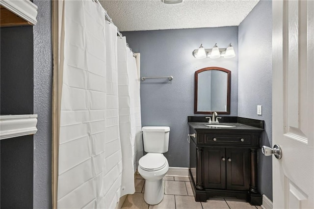 bathroom featuring vanity, a textured ceiling, toilet, and tile patterned flooring