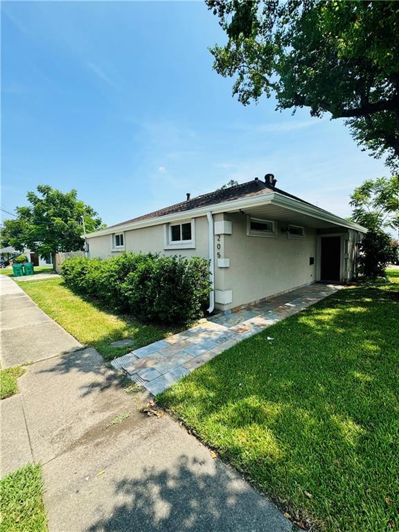 view of side of home featuring a yard