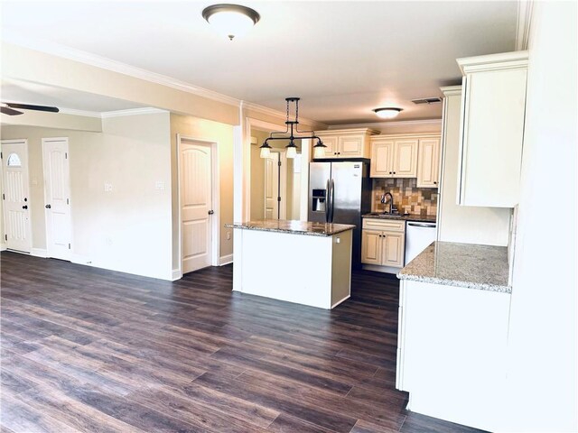 kitchen with dark stone countertops, dark wood-type flooring, stainless steel appliances, hanging light fixtures, and ceiling fan