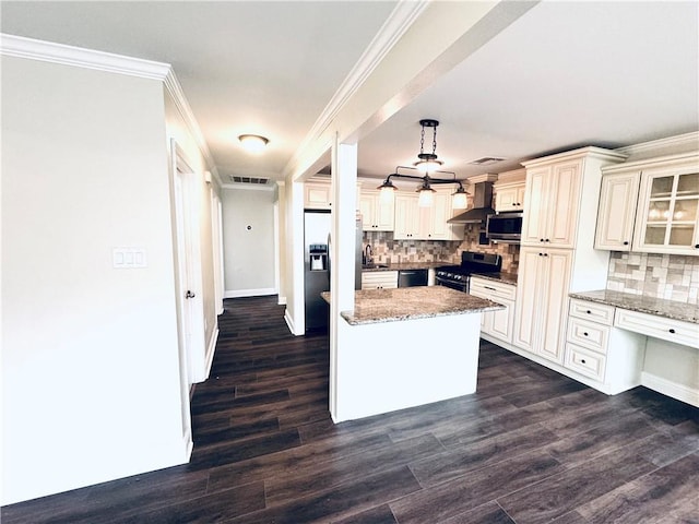 kitchen featuring sink, hanging light fixtures, ornamental molding, stainless steel appliances, and wall chimney exhaust hood