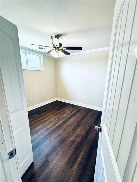 empty room featuring ceiling fan and hardwood / wood-style flooring