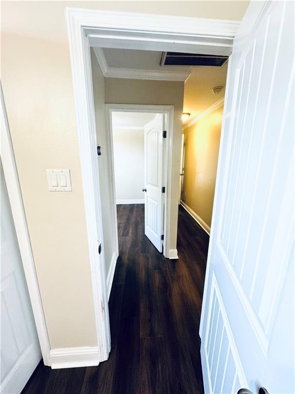 hallway featuring ornamental molding and hardwood / wood-style flooring