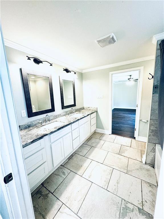 bathroom featuring ceiling fan, ornamental molding, vanity, and tile patterned flooring