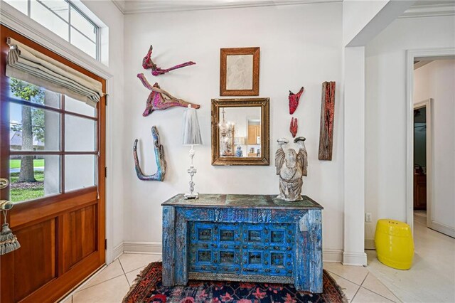 1034 Foy St, Mandeville, LA 70448 - entryway featuring light tile patterned floors, baseboards, and crown molding
