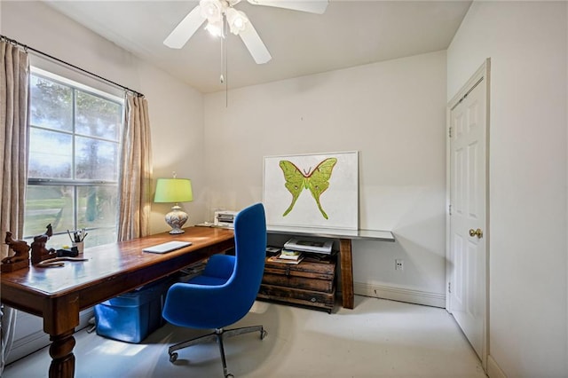 1034 Foy St, Mandeville, LA 70448 - home office featuring a ceiling fan, finished concrete flooring, and baseboards