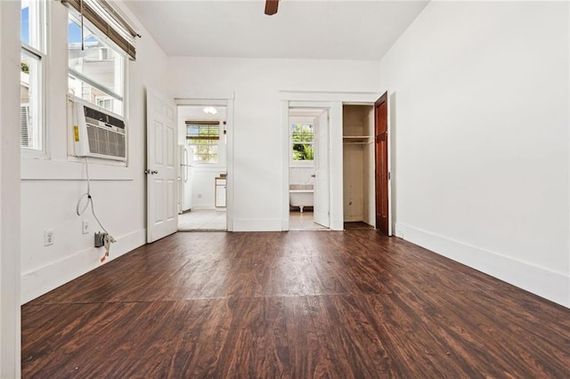 unfurnished room with wood-type flooring, cooling unit, and ceiling fan