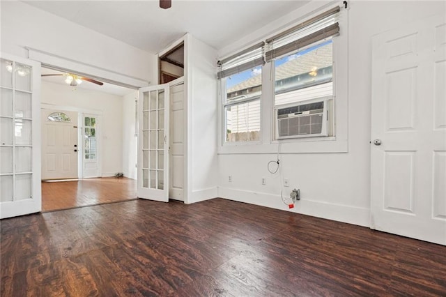 interior space with french doors, cooling unit, ceiling fan, and dark wood-type flooring