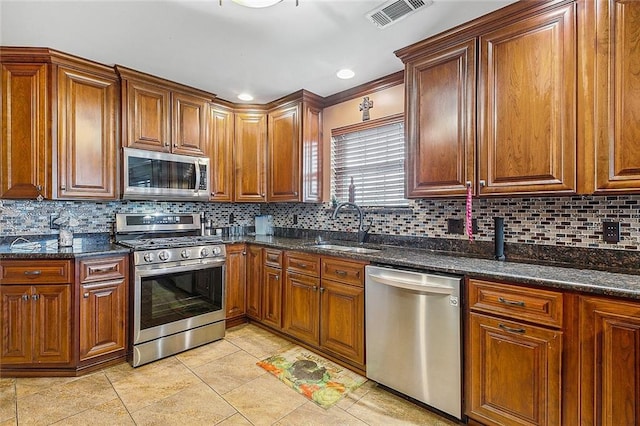 kitchen with decorative backsplash, stainless steel appliances, and sink