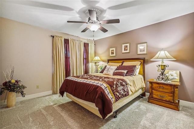 bedroom featuring light carpet and ceiling fan