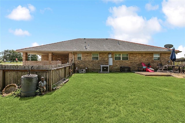 rear view of house with a yard, a patio, and central air condition unit