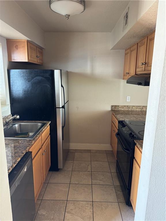 kitchen featuring light tile patterned flooring, sink, black range with electric stovetop, and dishwasher