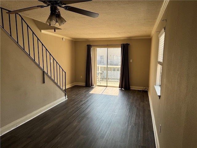 interior space featuring dark hardwood / wood-style flooring, ceiling fan, crown molding, and a textured ceiling