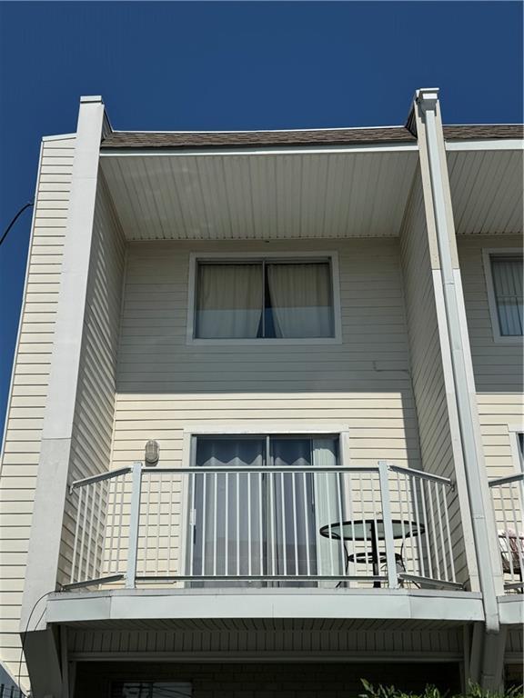 back of house featuring a balcony