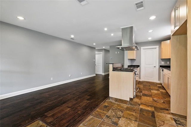 kitchen featuring dark wood-type flooring, range, and island exhaust hood