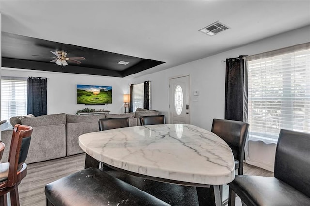 dining area featuring ceiling fan, a wealth of natural light, and light hardwood / wood-style floors