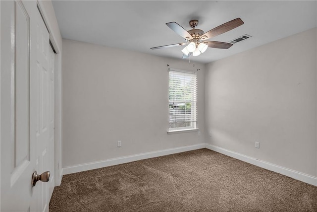 empty room with ceiling fan and carpet floors