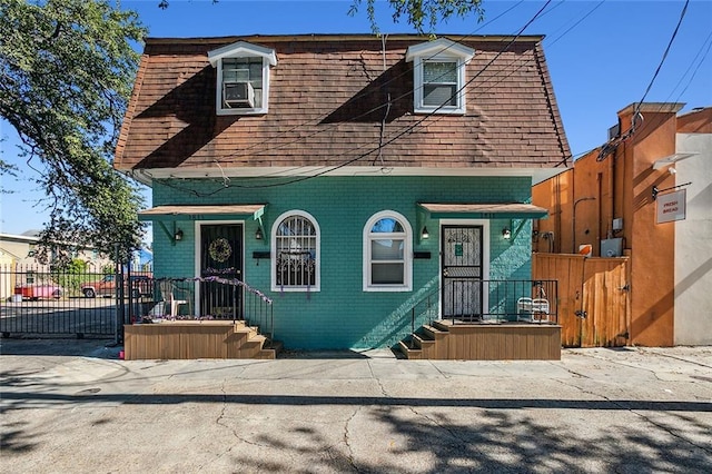 view of front of home featuring fence