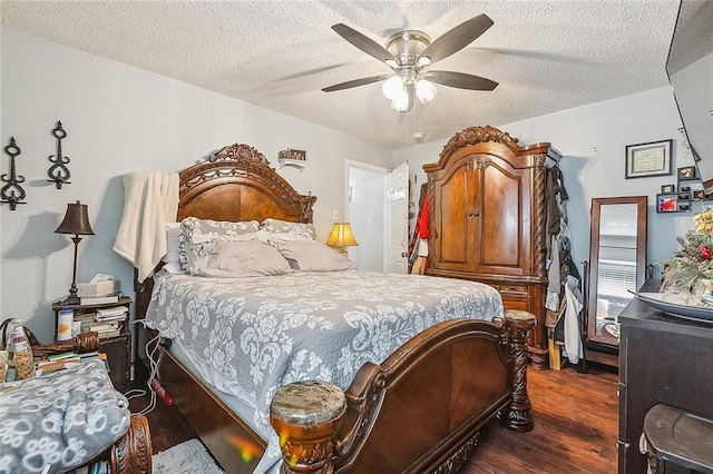 bedroom featuring dark wood finished floors, ceiling fan, and a textured ceiling