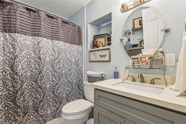 bathroom featuring toilet and vanity