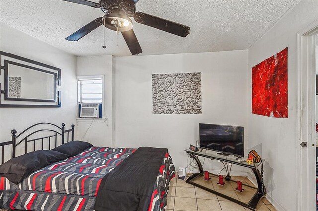 bedroom featuring cooling unit, ceiling fan, light tile patterned flooring, and a textured ceiling