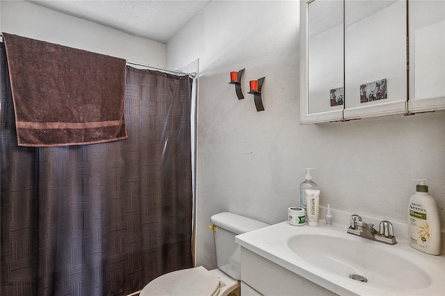 bathroom featuring vanity, toilet, and a shower with curtain