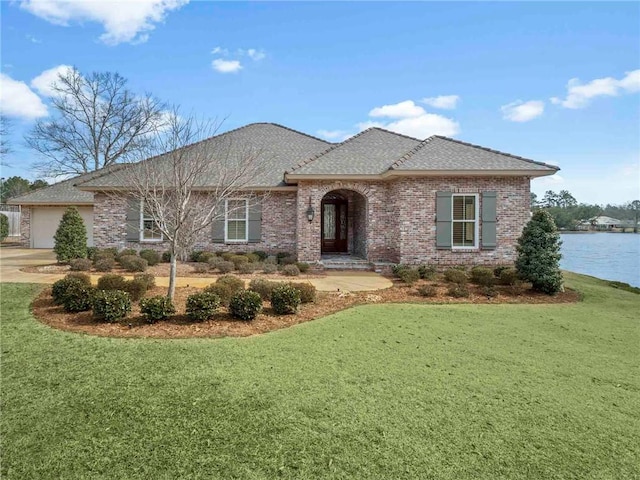 view of front of home with a front lawn and a garage