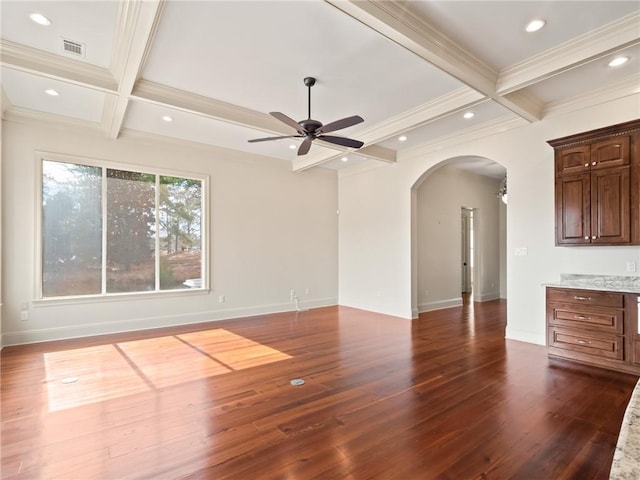 empty room with beam ceiling, coffered ceiling, and hardwood / wood-style floors