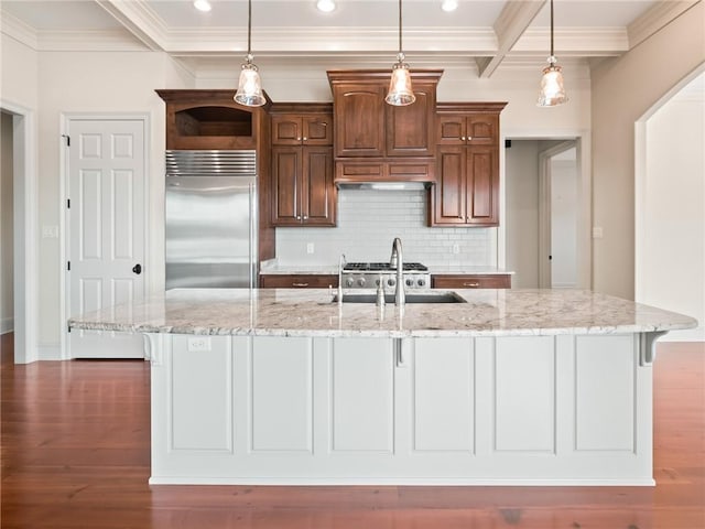 kitchen featuring tasteful backsplash, stainless steel built in fridge, a large island, and hardwood / wood-style floors