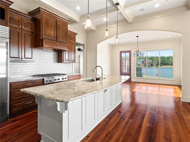 kitchen with sink, tasteful backsplash, pendant lighting, and dark hardwood / wood-style floors