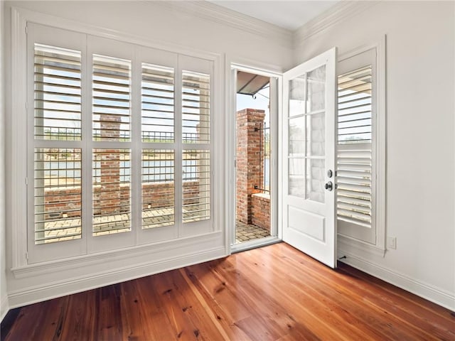 doorway featuring hardwood / wood-style floors and ornamental molding