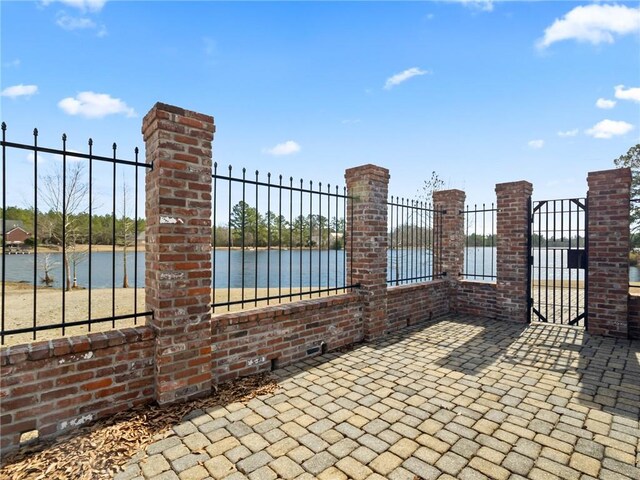 view of gate featuring a water view