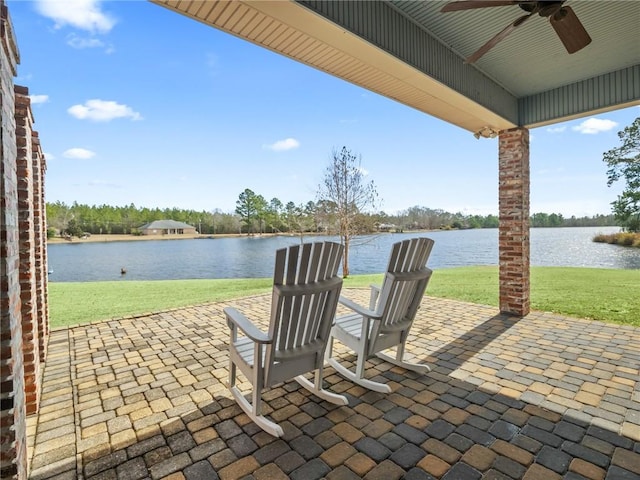 view of patio featuring a water view and ceiling fan