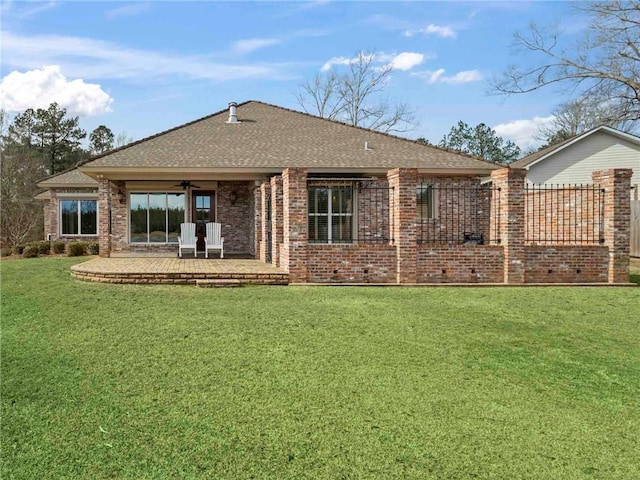 rear view of house featuring a yard and a patio area