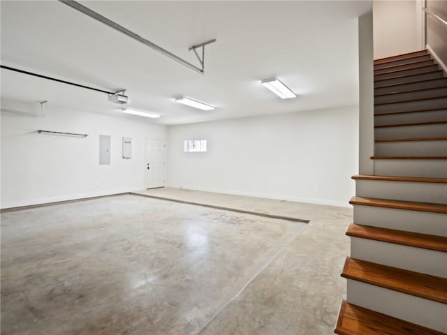 garage featuring electric panel and a garage door opener