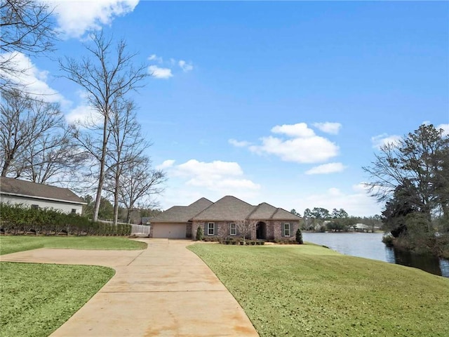 view of front of house with a front lawn and a water view