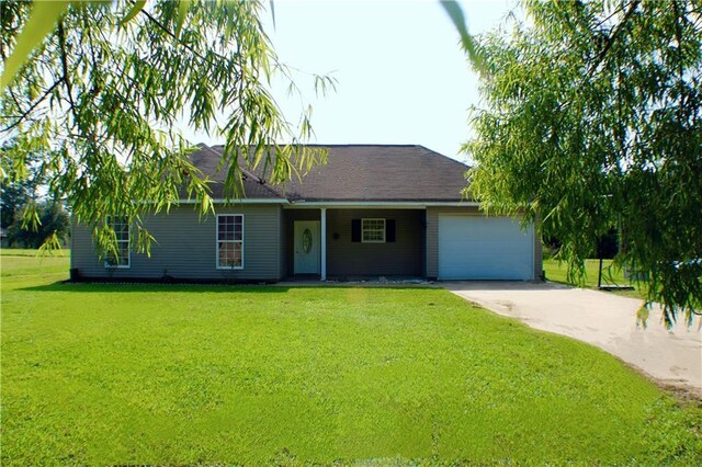 single story home featuring a garage and a front lawn