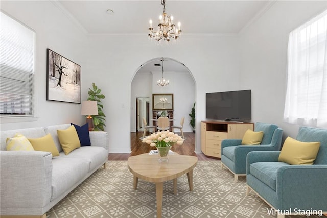 living room featuring ornamental molding, an inviting chandelier, and hardwood / wood-style flooring