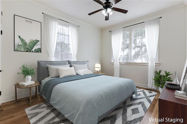 bedroom with wood-type flooring, ornamental molding, and ceiling fan