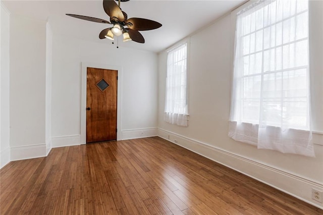 spare room featuring wood-type flooring and ceiling fan