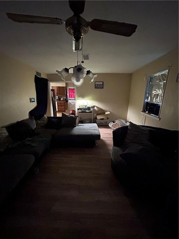 living room featuring ceiling fan and wood-type flooring