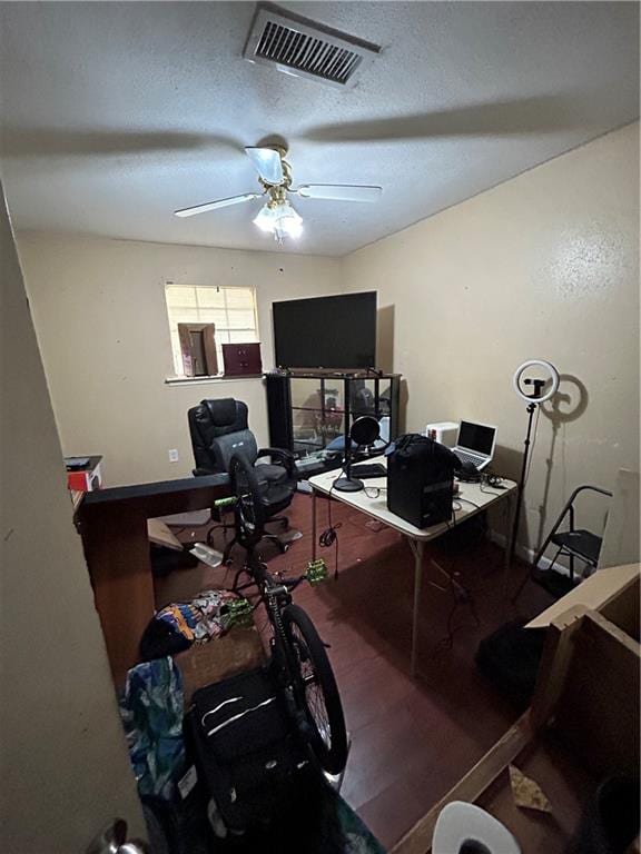 office featuring ceiling fan and a textured ceiling