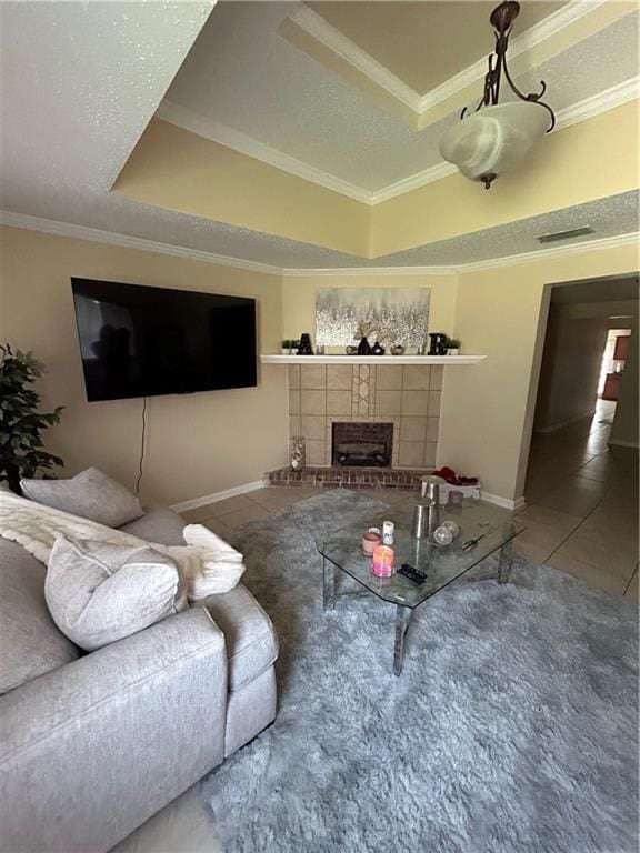 living room featuring crown molding, a tray ceiling, and tile patterned flooring