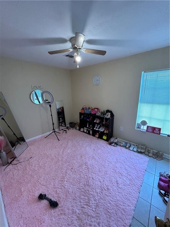 miscellaneous room with ceiling fan and light tile patterned flooring