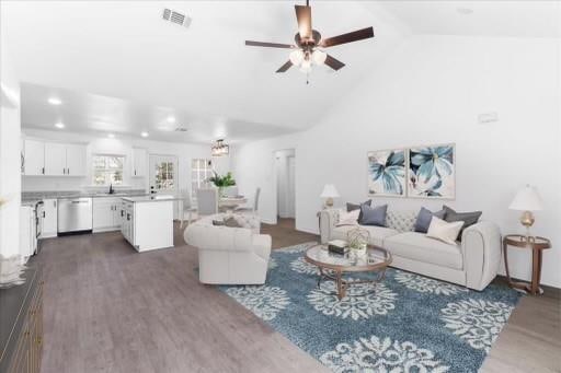 living room featuring high vaulted ceiling, dark wood-type flooring, and ceiling fan