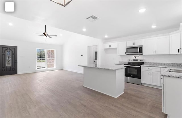 kitchen featuring ceiling fan, light wood-type flooring, white cabinets, and stainless steel appliances