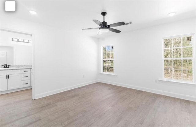 interior space with ceiling fan, light hardwood / wood-style flooring, and a wealth of natural light