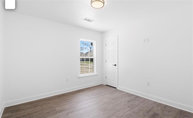 unfurnished room featuring wood-type flooring